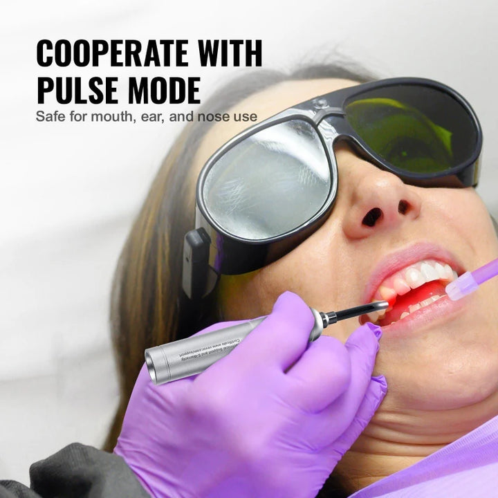 Professional demonstrating the RelaxRiser™ DualGlow Red Light Wand with pulse mode for oral application, showing safe use for gums with protective eyewear in a clinical setting.